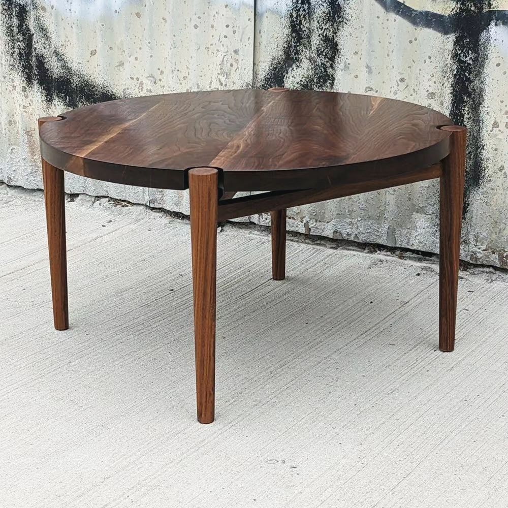 August 9th, 2023: This modern walnut coffee table features a unique circular top that appears to float above its supports.